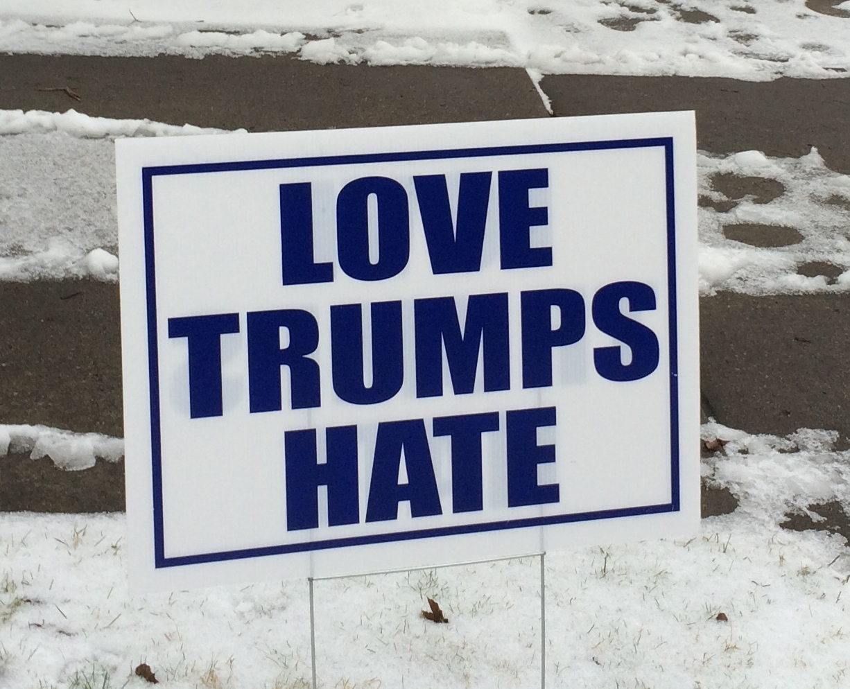 Village Life:  One sign leads to another, but does “Love Trump Hate”?