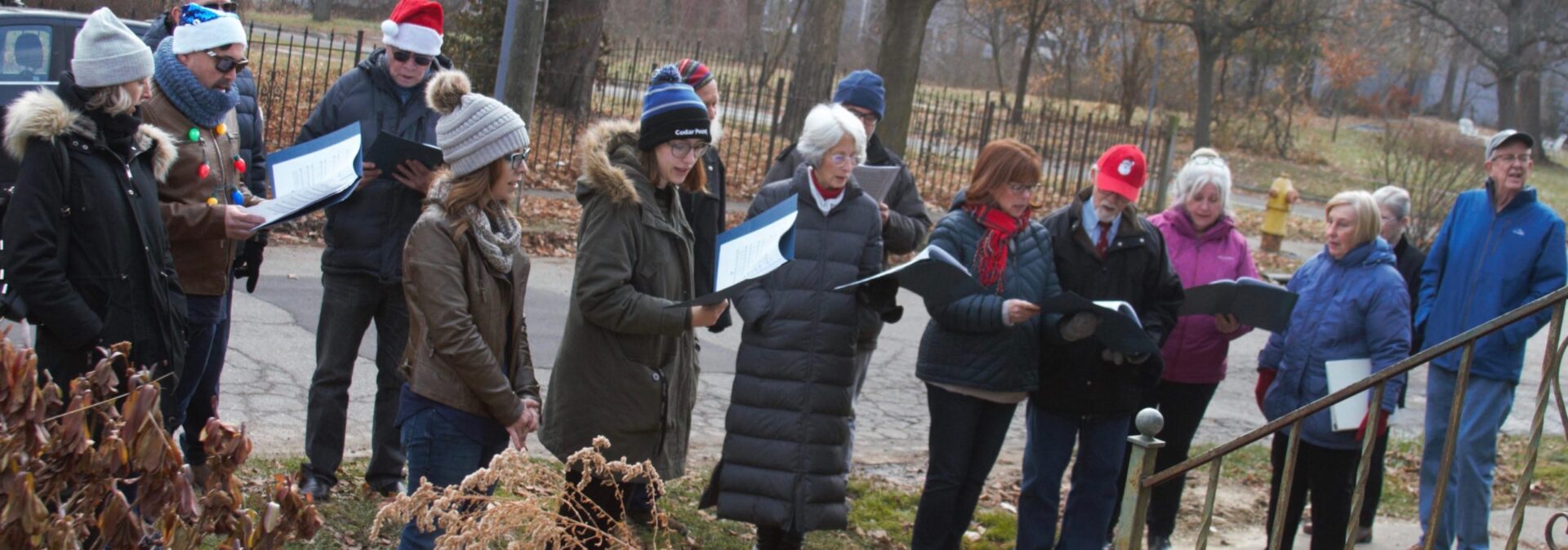 LGBTQ Choir honors John Bradford Bohl with Carriage Town caroling